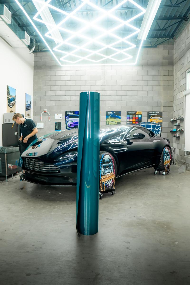 Teal film staged next to the Aston Martin in the studio