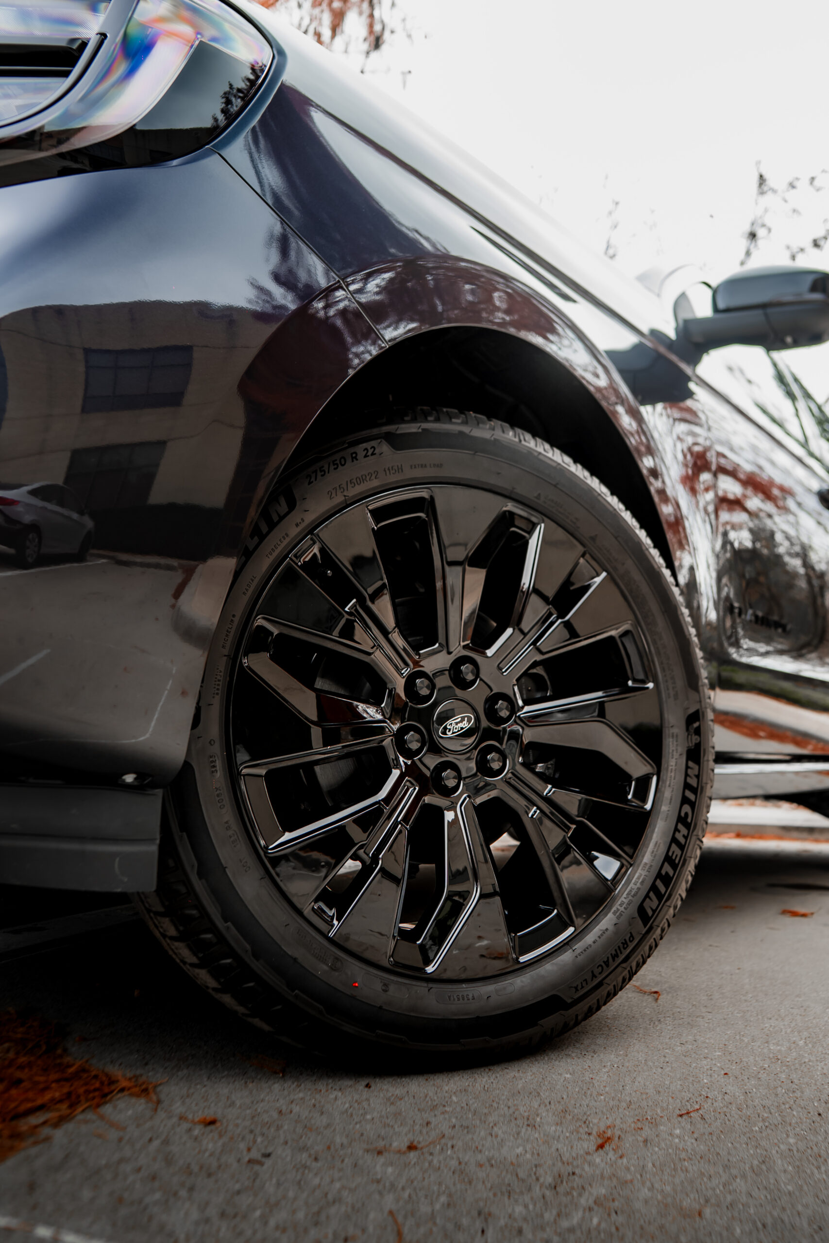 Blacked out Ford wheel and gloss color shift fender after a chrome delete