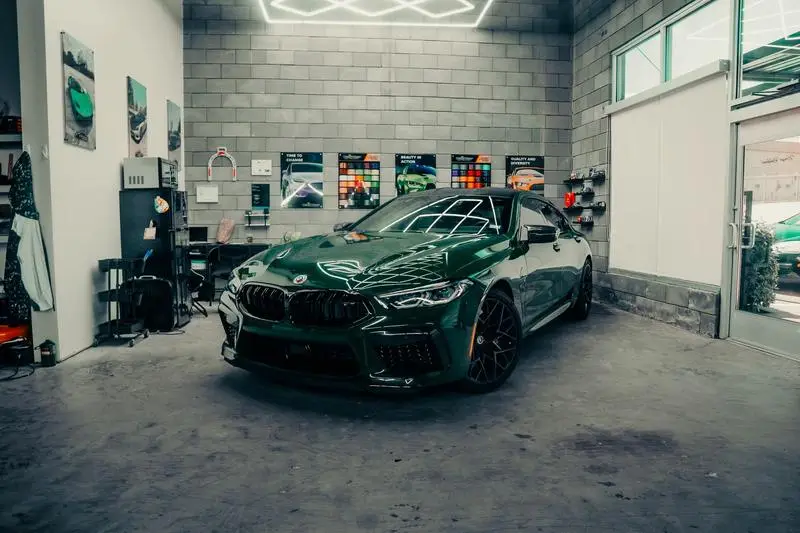 Deep green BMW coupe in the Wraps Redefined studio