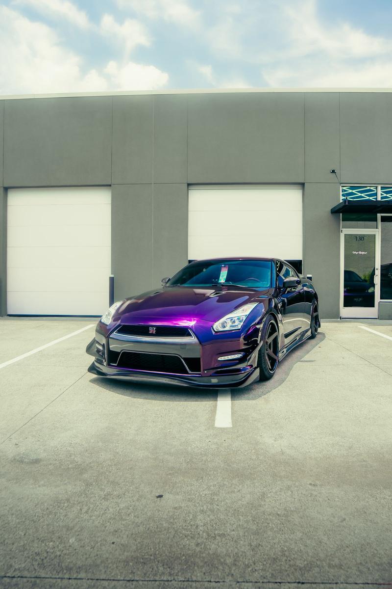 Purple muscle car protected with colored PPF outside the studio
