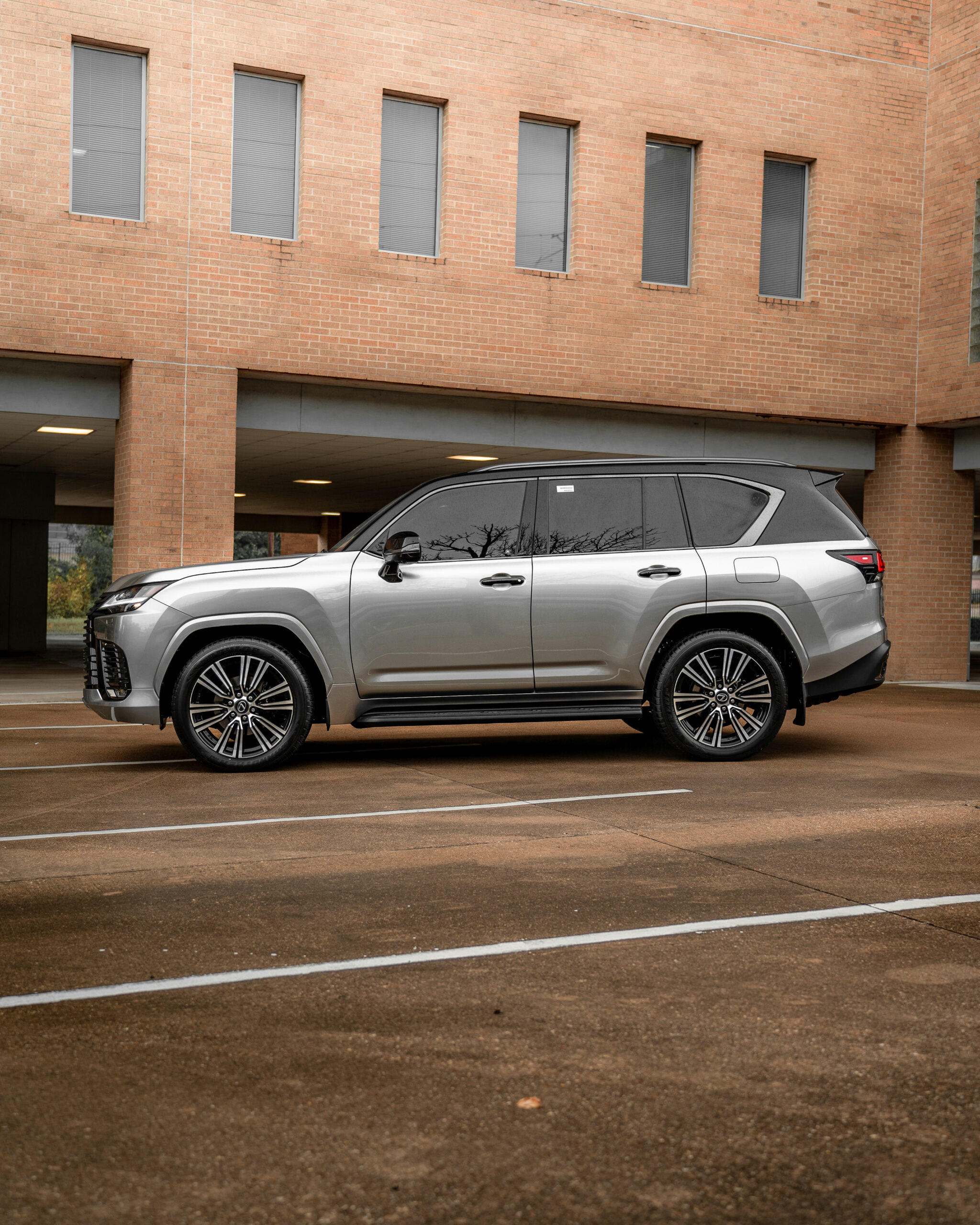 Silver Lexus LX staged for a tuxedo wrap package spec at the Wraps Redefined studio