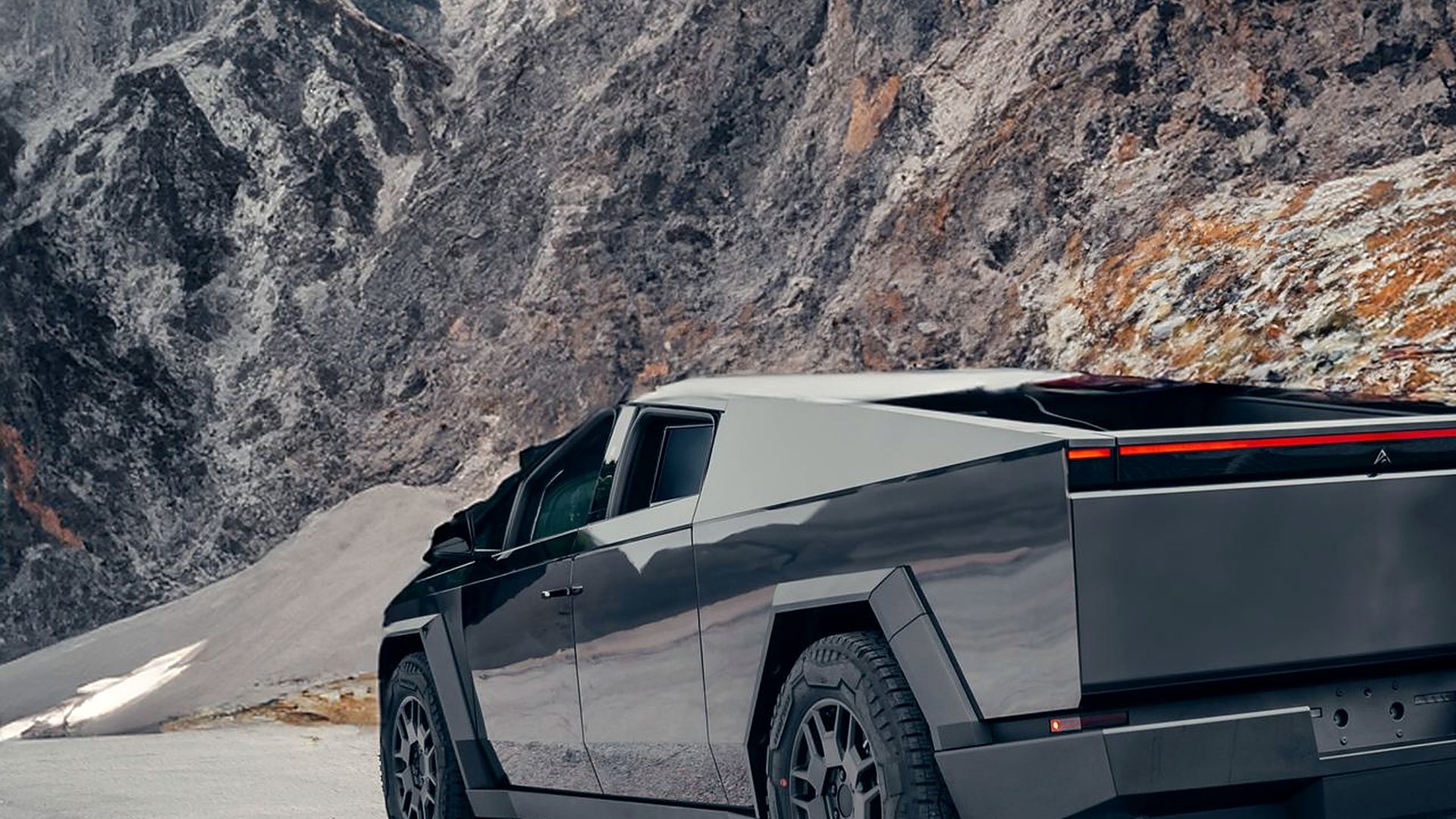 Tinted Tesla Cybertruck photographed against the mountains